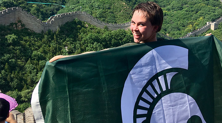 woman holding spartan flag over her back